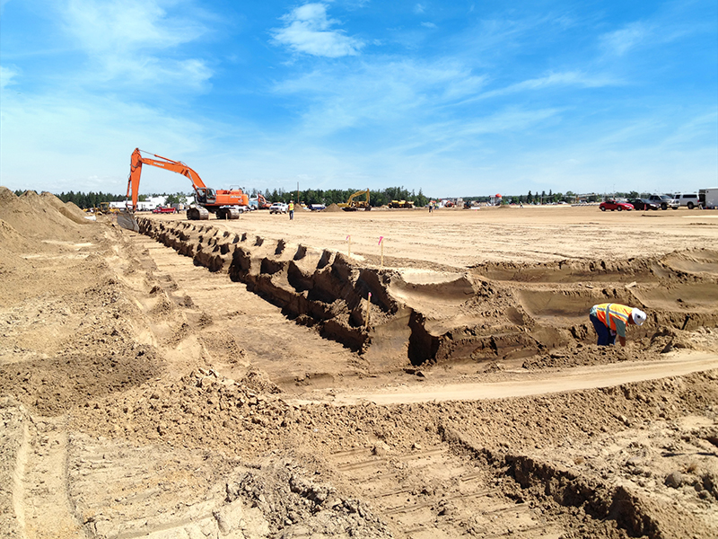 Excavator digging trench